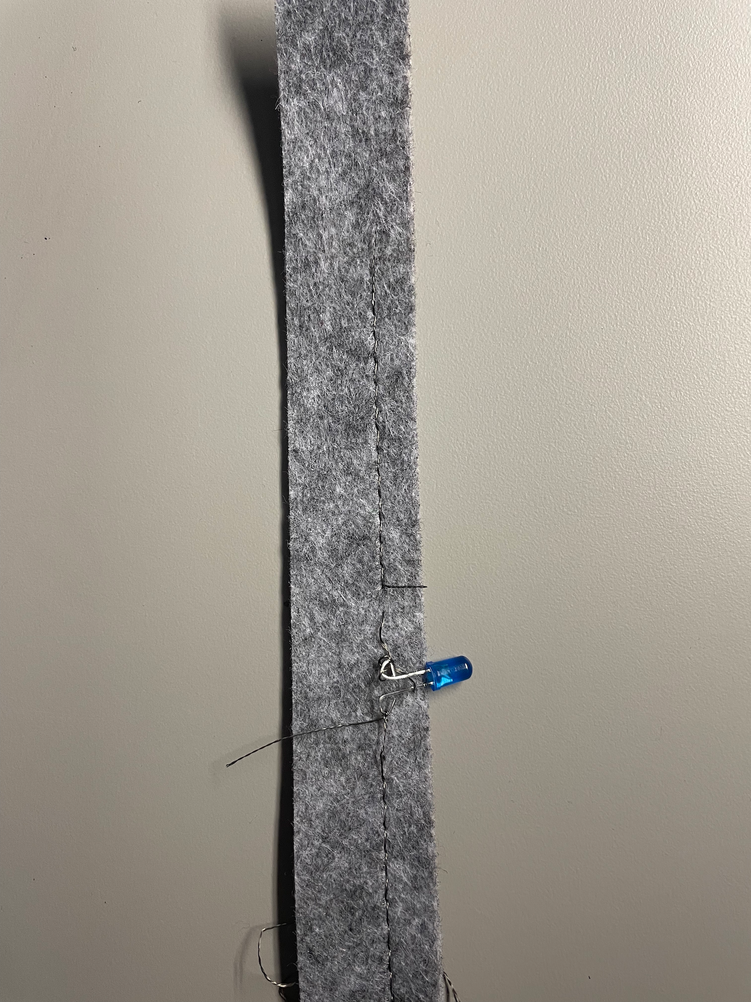 After chatting with Jen I bent the LED wired to easily connect with the thread, I was 
                  reminded of J hooks when making this. I was fustrated when attatching the thread because it 
                  does not keep its shape. Eventually with a slip not I made the thread work but now I am weary 
                  of using it in the future because of how finiky it is to use.